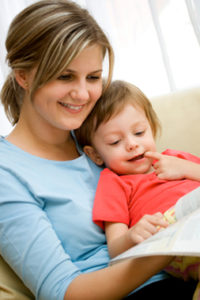 Mother and 20 months old child reading picture book